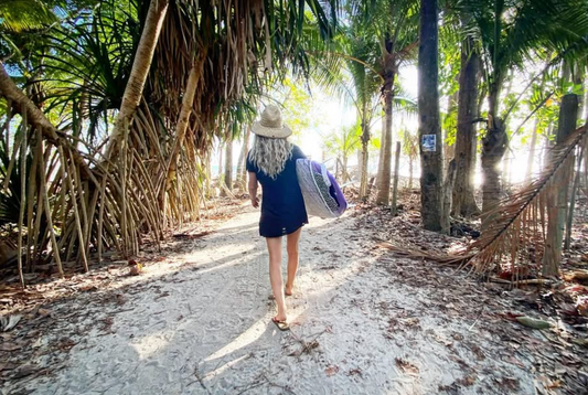 Surfer Woman Walking through jungle beach