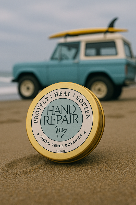 Hand repair balm container on a beach with a vintage car in the background

