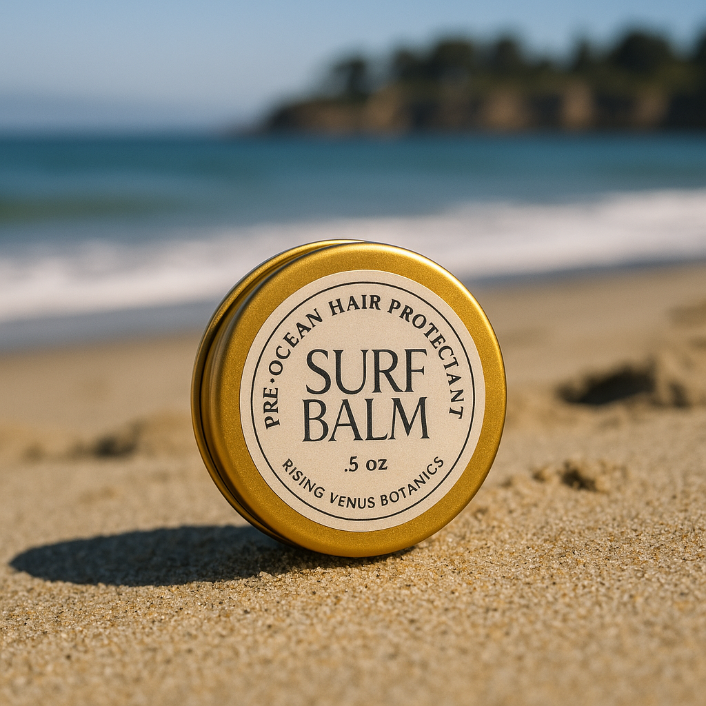 Surf Balm container on a sandy beach with ocean in the background