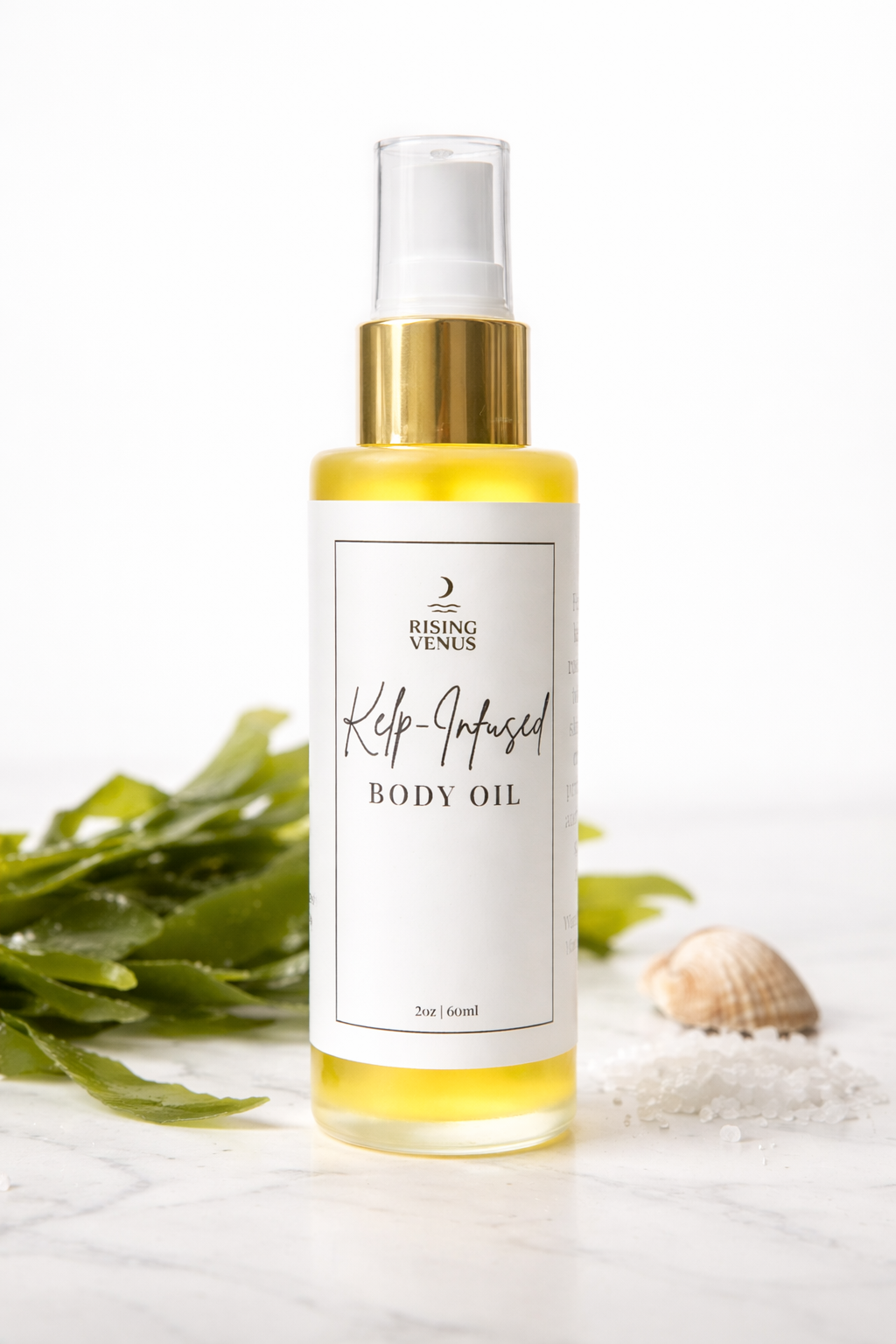Bottle of kelp body oil on table with seaweed and seashell